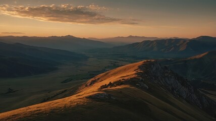 Fototapeta premium Golden hour illuminates a vast mountain range with a serene valley view