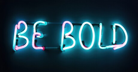 Bright neon sign displays text BE BOLD. Turquoise, pink hues illuminate dark background. Inspiring message, simple design.