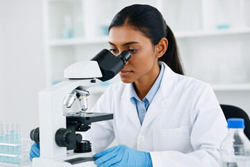 Focused scientist using microscope for medical research in lab, developing innovative treatments, modern medicine for healthier future, healthcare