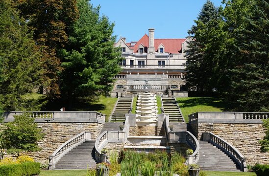 Loretto, Pennsylvania, U.S - Aug 9, 2025 - The Limestone Castle overlooks a cascading water feature and tiered staircases, framed by lush green trees in Mount Asisi Gardens