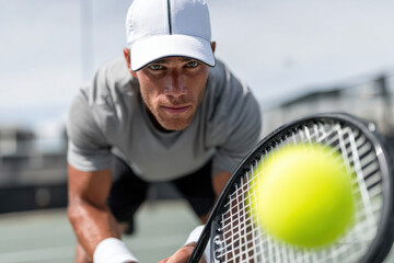 A tennis player preparing for serve with concentration