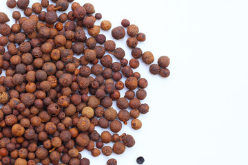Brown dried allspice spice seeds.