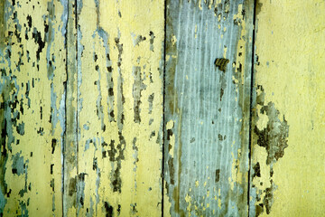 Obraz premium Aged Wood Planks with Peeling Yellow and Blue Paint in Distress