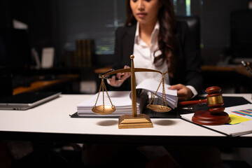 Female lawyer is working on legal documents in an office.	
