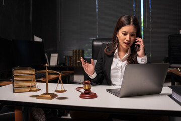 Female lawyer is working on legal documents in an office.	