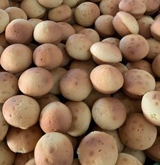 This picture shows a pile of traditional Indonesian sponge cakes known as kue cubir/kue cubit bulat.