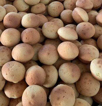 This picture shows a pile of traditional Indonesian sponge cakes known as kue cubir/kue cubit bulat.