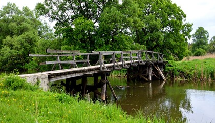Old wooden bridge over a river in a lush green landscape