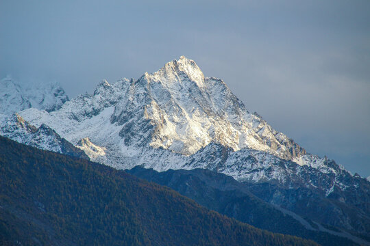 Jagged, snowy peaks loom under a cloudy sky
Yala Snow Mountain, Sichuan, China