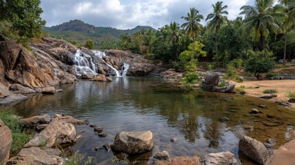 Picturesque Waterfall Flowing into a Tranquil Pool Surrounded by Lush Nature