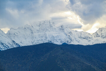 Jagged, snowy peaks loom under a cloudy sky
Yala Snow Mountain, Sichuan, China