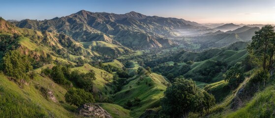 Scenic view of lush green rolling hills and mountain landscape du daytime with clear sky and distant horizon