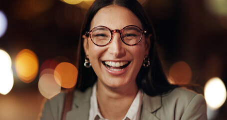 Portrait, business and woman in city at night for travel, about us and bokeh with career pride. Female person, laugh and glasses with positive attitude for commute, urban consultant and opportunity © peopleimages.com