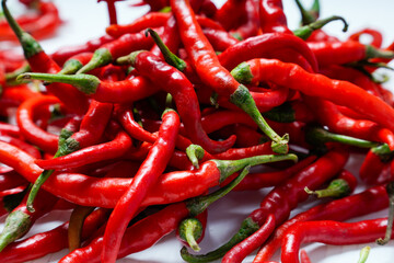bunch of red chilies full frame on white background.