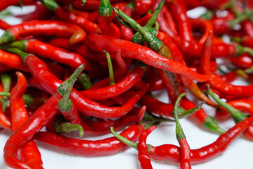 bunch of red chilies full frame on white background.