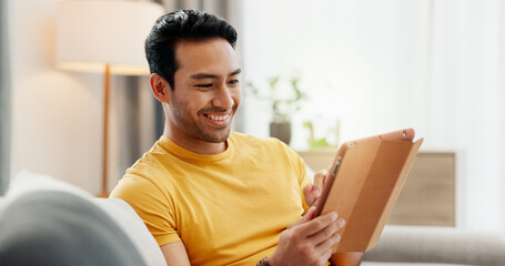 Tablet, relax and happy man in home for internet, social media post and reading news. Technology,...