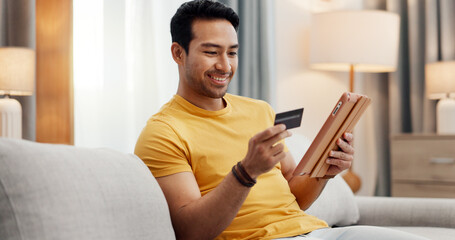 Online shopping, credit card and happy man on tablet in home for purchase, payment and...