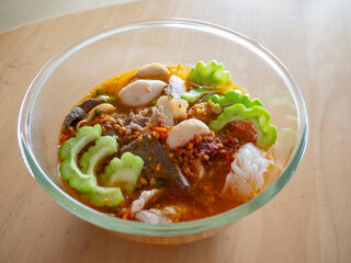 Traditional Thai Tom Yum Noodle Soup with Pork, Meatballs, Dried Shrimp and Pork Liver in Authentic Local Style Street Food Cuisine.