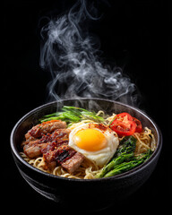 Steaming hot bowl of delicious asian noodle soup with egg and vegetables