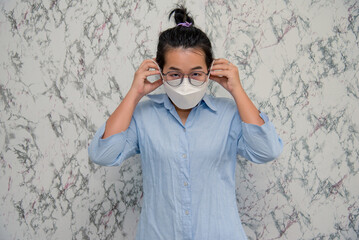 elegant womanman wearing a mouth protection to prevent getting sick at work or on the way to work isolated on White background, pandemic and social distancing concept.Covid-19