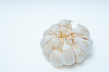close up view of fresh whole garlic isolated in white for advertising space.