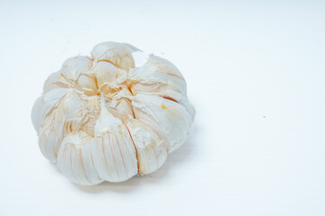 close up view of fresh whole garlic isolated in white for advertising space.