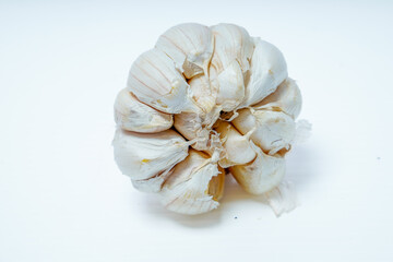 close up view of fresh whole garlic isolated in white for advertising space.