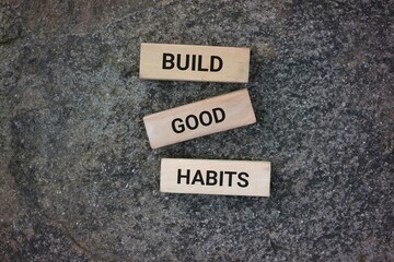Wooden blocks arranged on a textured surface displaying the motivational phrase 