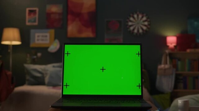 Laptop with Green Screen in a Bedroom