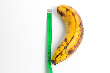 Ambon banana and meter isolated on white background. concept of measuring male genitalia