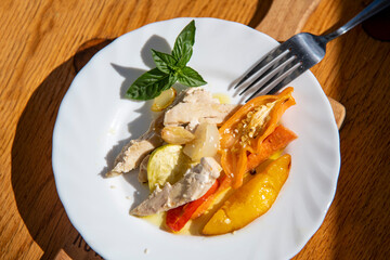Delicious baked dish featuring tender white meat with fresh peaches and seasonal vegetables. 