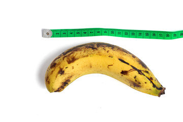 Ambon banana and meter isolated on white background. concept of measuring male genitalia