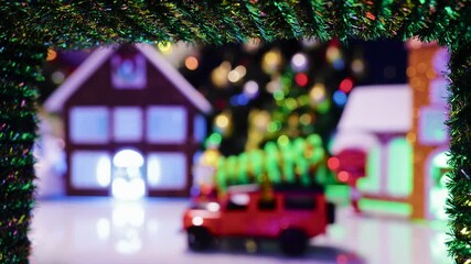 In the middle of the Christmas wreath is a half-blurred Christmas town