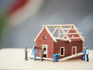 Mini toy of action figure at table with blurred background. Miniature photography concept. Building...