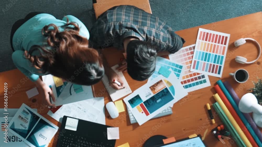Poster top down view of smart designer helping manager choosing color from colored palettes. aerial view of