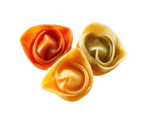Three tortellini, one orange, one light yellow-tan, and one green-tan, arranged in a loose triangle, on black background