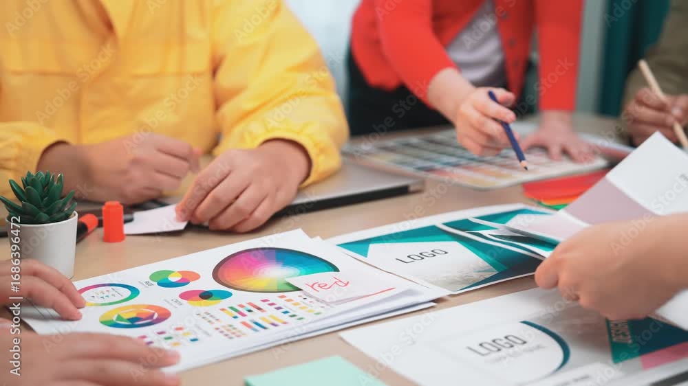 Poster a diverse group of designers collaborating on a vibrant color palette and design project at a modern