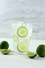 Mojito Cocktail in a Tall Clear Glass with Lime, Soda and Ice.