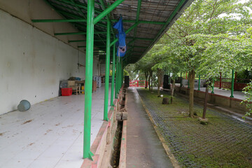 Empty Outdoor Corridor with Green Beams