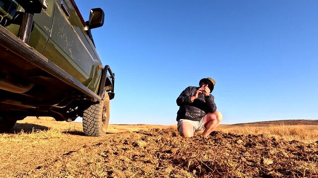 Field guide on safari explains to tourists how rhinos use dung to mark territory