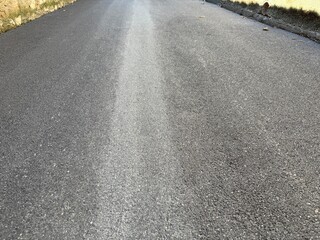 asphalt road with yellow lines