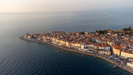 Aerial view of the town of Piran on the Adriatic peninsula. View from above of the old town and the coast at sunset, a popular travel destination