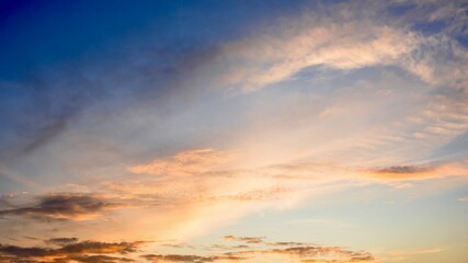 sunset in the sky, Orange-pink sunrise clouds on a deep blue morning sky.