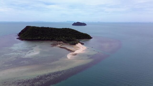 Aerial drone footage flying over Ko Tae Nai island near Koh Phangan, showcasing crystal clear waters, tropical coastline, and lush greenery.