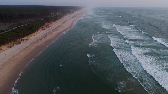 aerial of maceda beach in s pedro ovar portugal with waves breaking along sandy coast