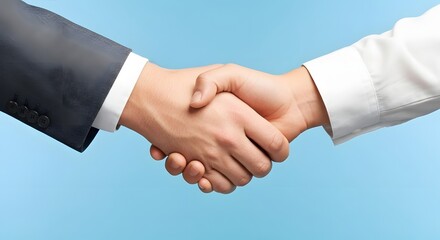 Two individuals in formal attire shaking hands, symbolizing agreement and cooperation.