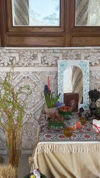 Vertical video of traditional ritual for Nowruz ceremony design Haftsin table Tehran palace outdoor garden mansion wooden frame plaster moulding festive spring Iranian culture architecture decoration