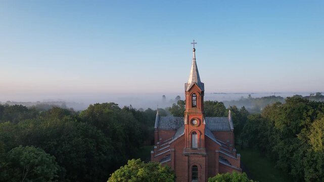 Church in the fog dawn in Krakes Lithuania