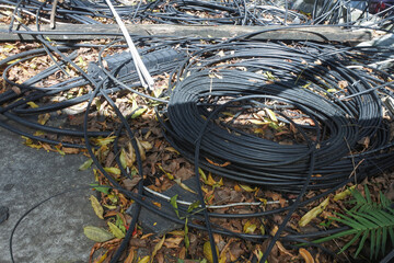 Electric poles with convoluted and chaotic electrical and telephone network cable installations are...