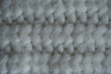 beige acrylic textile background beige knitted wool fabric texture close-up macro texture of beige knitted wool fabric as a background. soft yarn surface with smooth symmetrical knit pattern